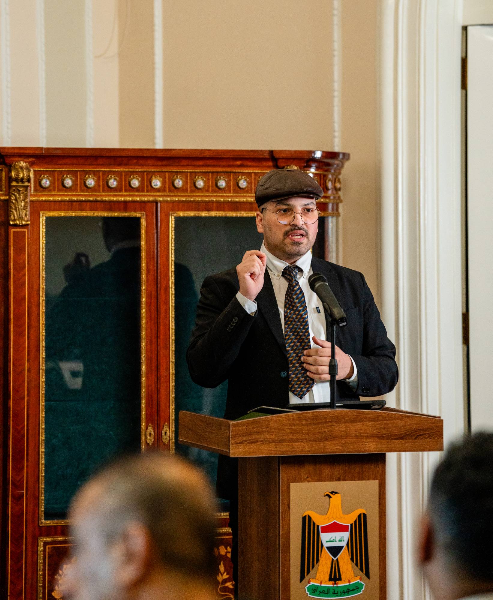A speaker addressing the audience from the podium